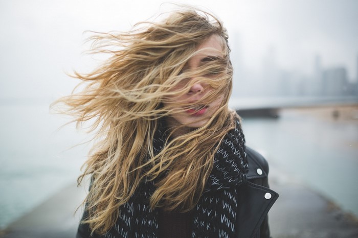 Woman with blonde hair blowing in the wind