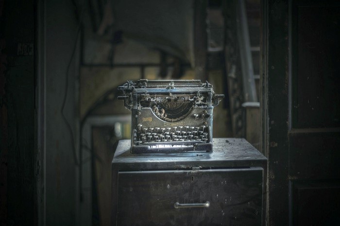 Old dusty Underwood typewriter on a filing cabinet