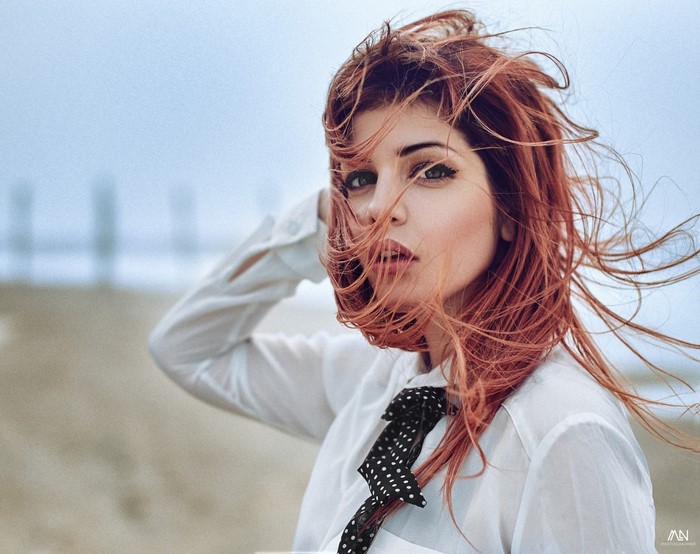 Woman with red hair in the wind