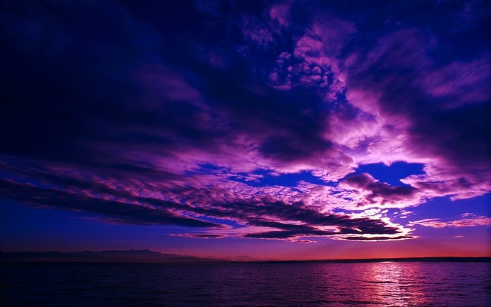 Vibrant Purple Sunset Over Calm Sea