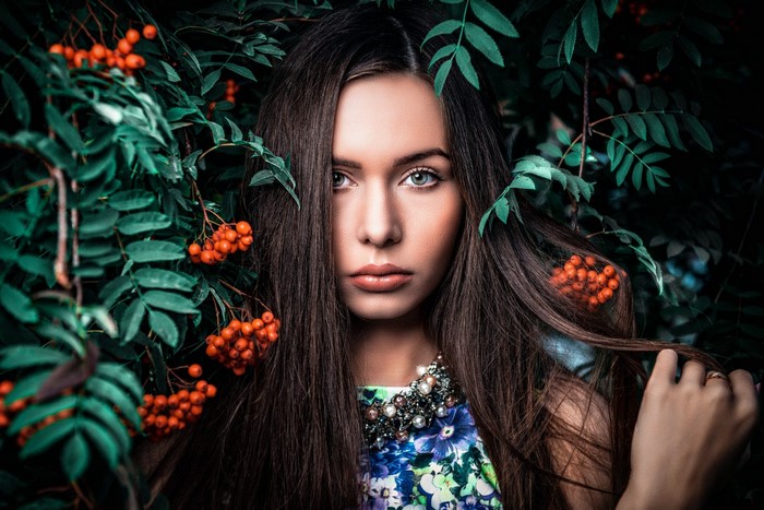 Woman with dark hair and flowers