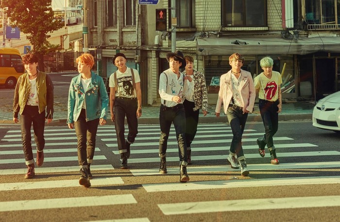 BTS Members Crossing Street in Urban Setting