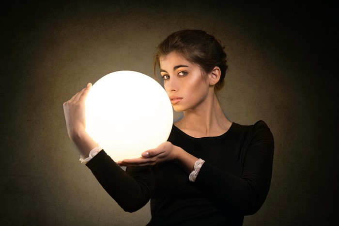 Woman holding a glowing orb