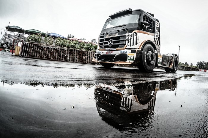 Mercedes-Benz racing truck on wet asphalt