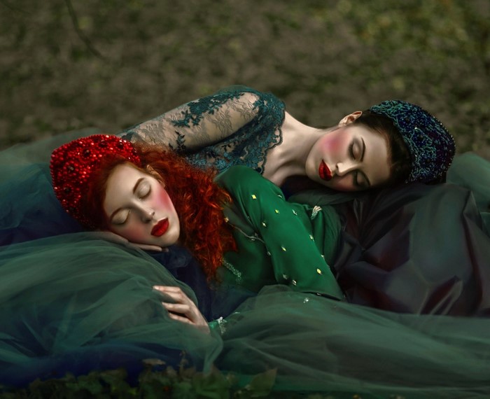 Two women sleeping in green dresses