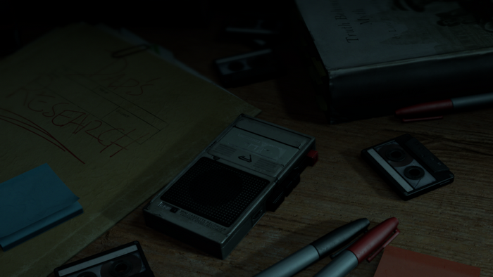 Research notes and audio recorder on a desk