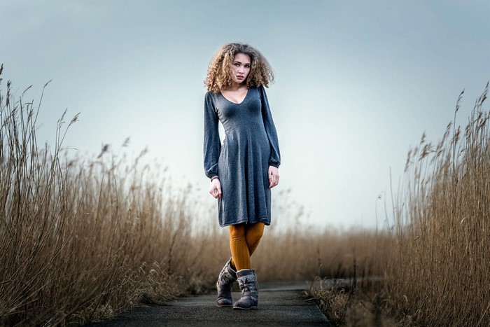 Woman in dress and boots in a field