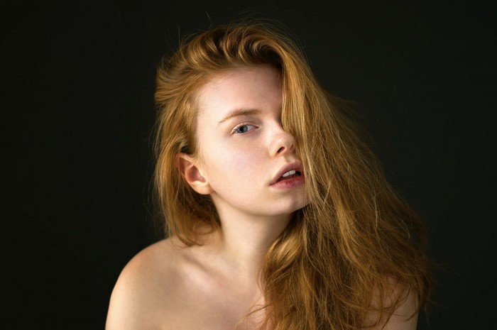 Portrait of a young woman with long red hair