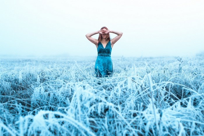Woman in blue dress in a frosty field