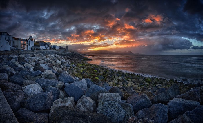 Sunset Over Rocky Shoreline in UK Coastal Town