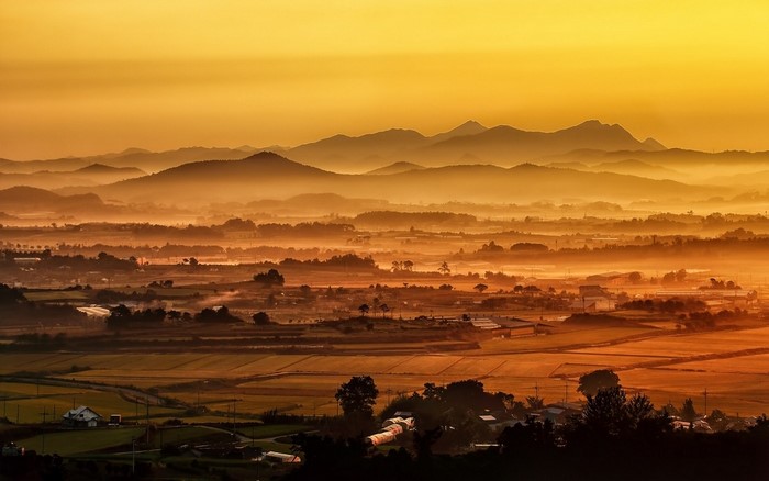 Misty mountain landscape at sunrise or sunset