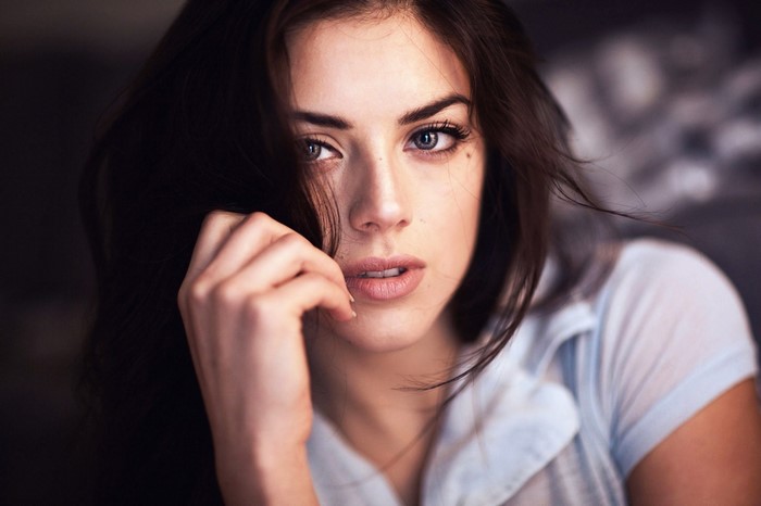 Woman with dark hair and blue eyes in a close-up portrait