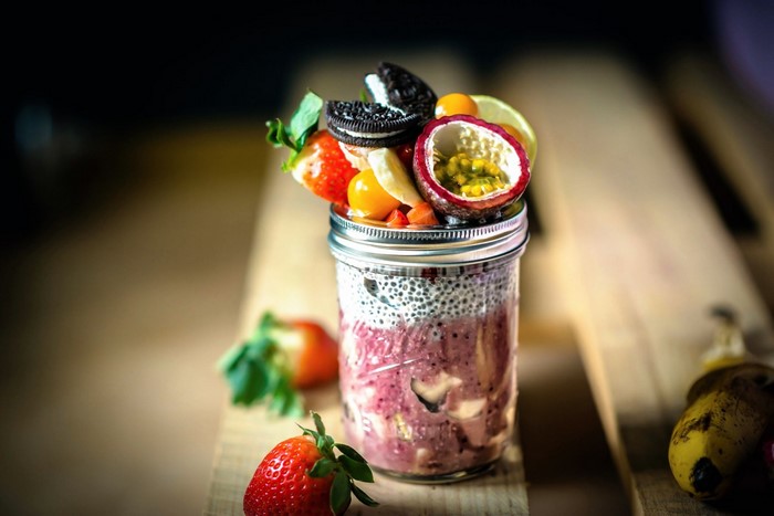 Jar of fruit parfait with strawberries and passion fruit