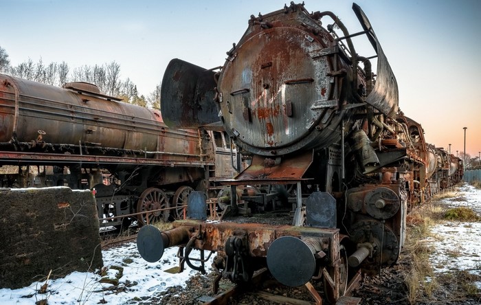 Abandoned rusty steam locomotives on tracks