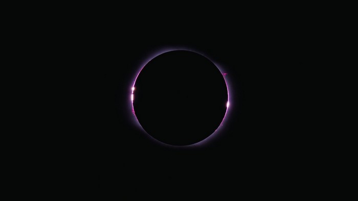 Solar eclipse with pink corona