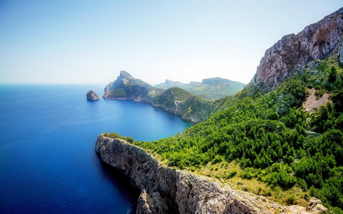 Coastal cliffs and mountains overlooking a blue sea