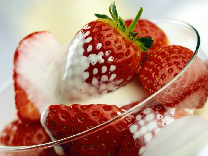 Strawberries with cream in a glass bowl