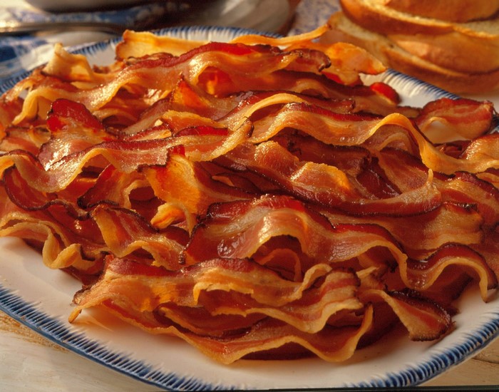 Plate of crispy fried bacon strips