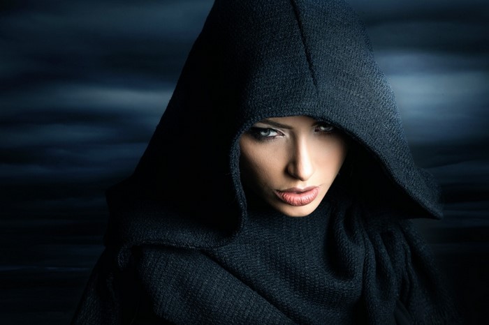 Woman in black hooded cape portrait