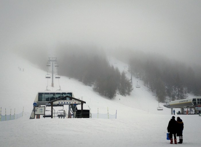 Ski lift station in foggy mountains