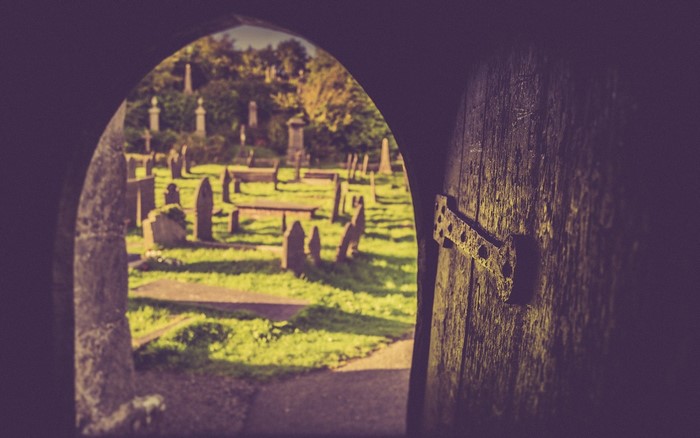 View of a cemetery through an arched doorway