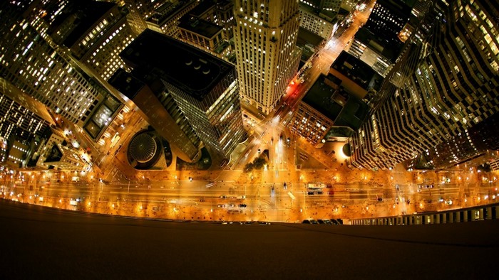 Aerial view of a city at night with illuminated buildings and streets