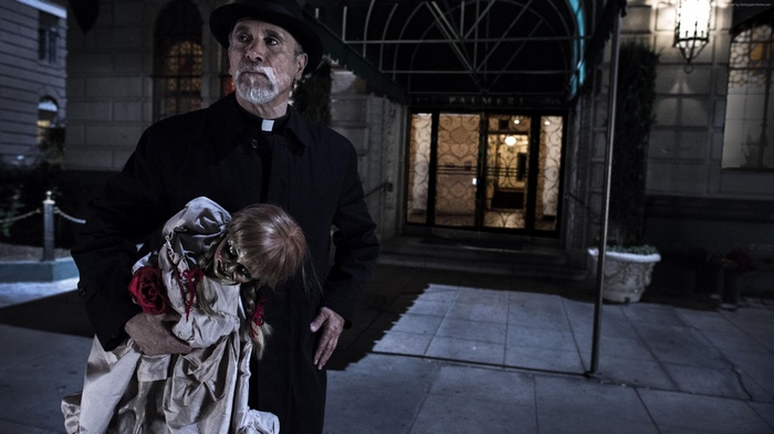Father Perez holding Annabelle doll from Annabelle 2: Creation