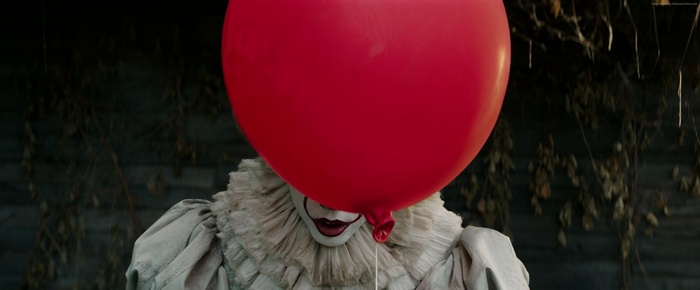 Pennywise the Clown from It holding a red balloon