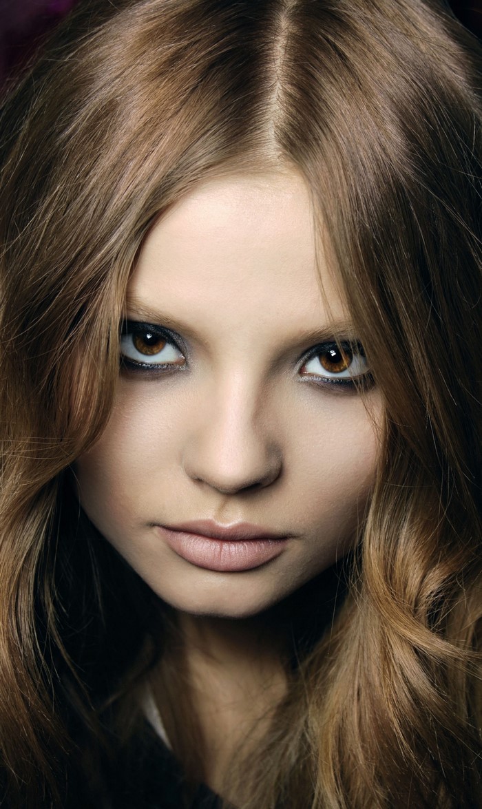 Close-up portrait of a young woman with brown hair