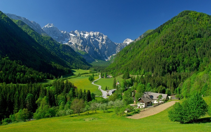 Green valley with mountains and houses