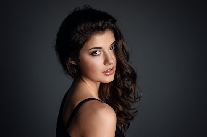 Woman with long brown hair in a black top
