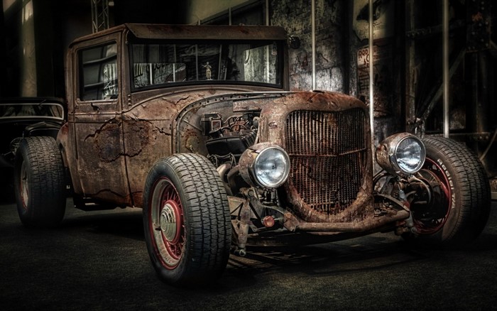 Rusty Hot Rod car with exposed engine and large tires