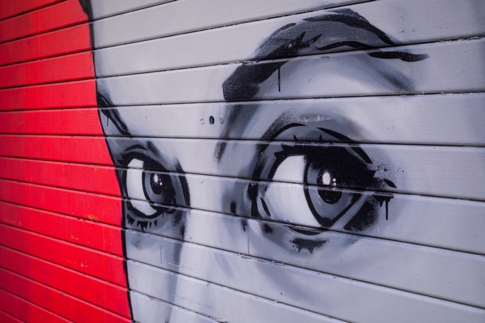 Graffiti of a face with red and gray sections
