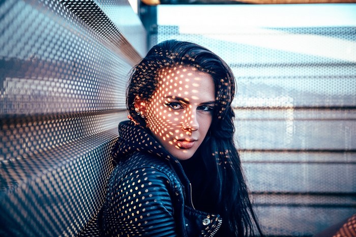 Woman with patterned light on her face