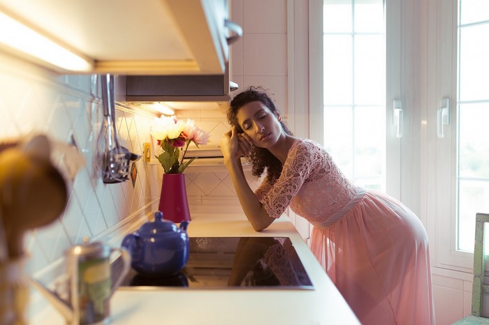 Woman in pink dress in a kitchen