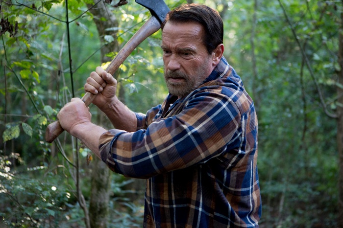 Arnold Schwarzenegger with an axe in the woods
