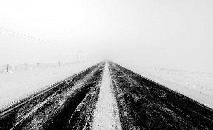 Snowy road in a whiteout fog