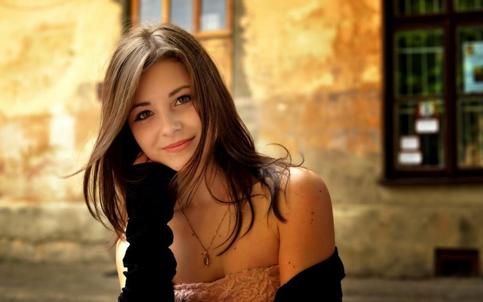Young woman with brown hair and black gloves