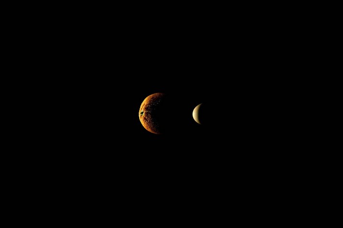 Orange and crescent moon in darkness
