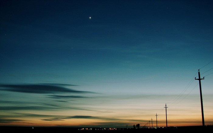 Twilight sky with stars and power lines