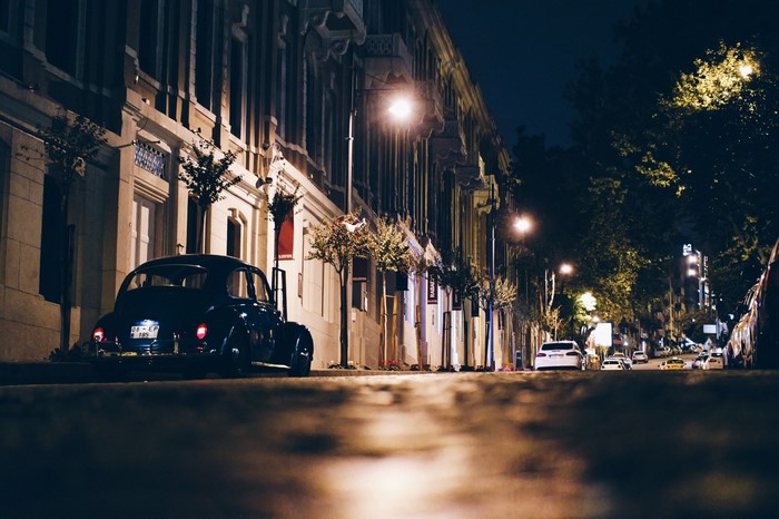 Vintage car on a city street at night
