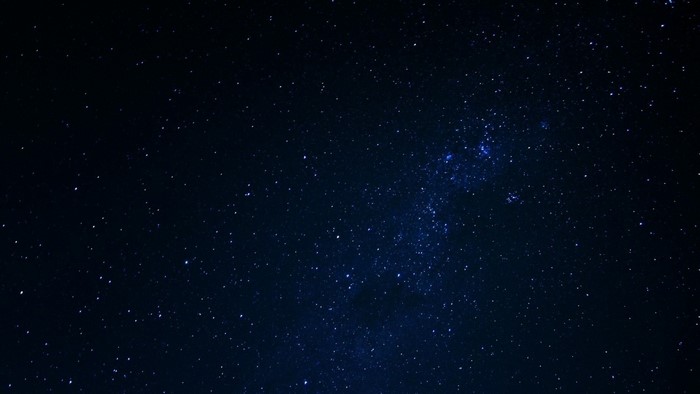 Night sky full of stars and a distant galaxy