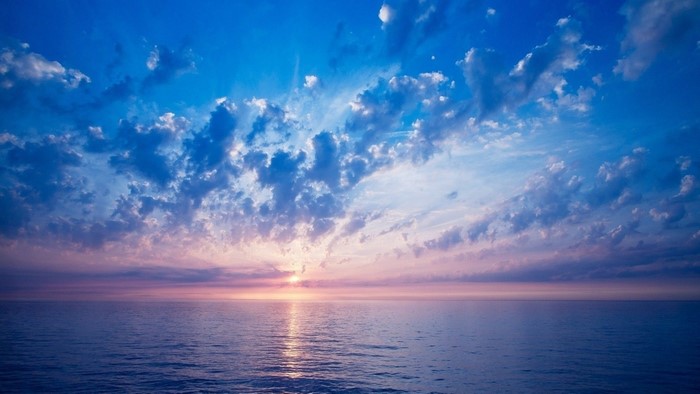 Sunset over the ocean with clouds