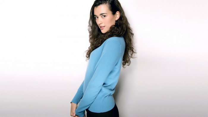 Cote de Pablo wearing a blue sweater