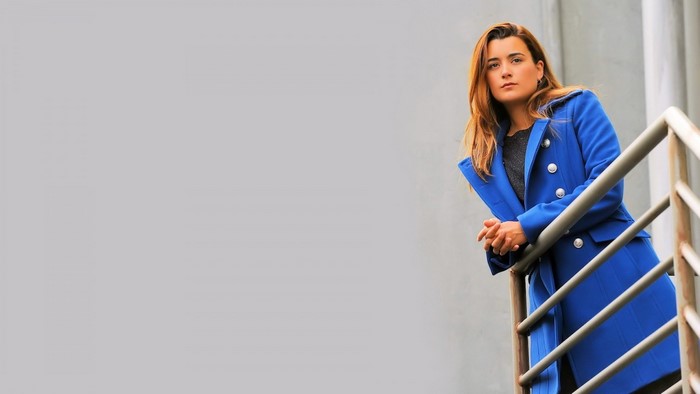 Cote de Pablo wearing a blue coat