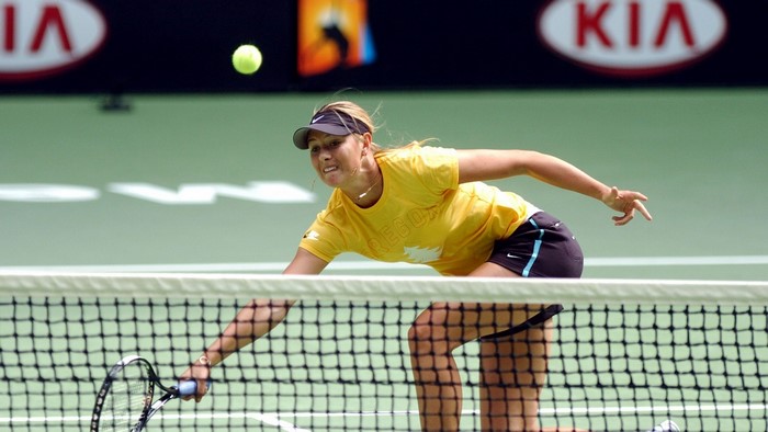 Maria Sharapova playing tennis at a tournament