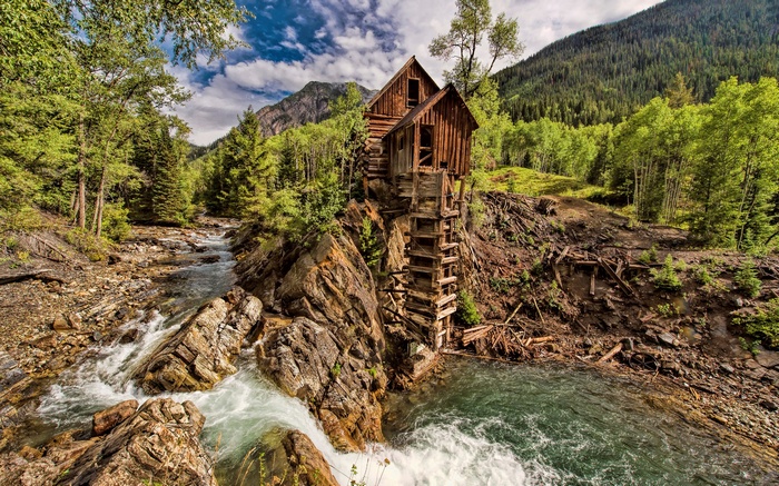 Wooden Mill on a Rocky Cliff Overlooking a River