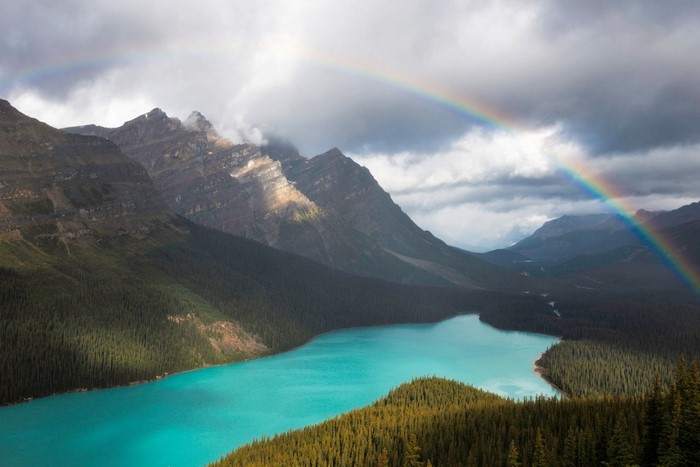 Turquoise lake and mountains with rainbow in Banff National Park