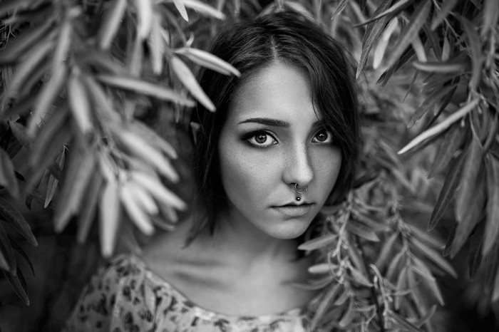 Monochrome portrait of a young woman with nose rings