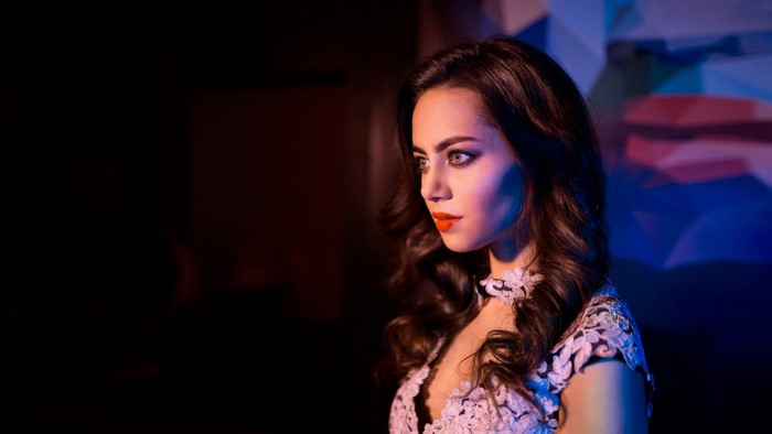 Woman in a white dress with orange lipstick